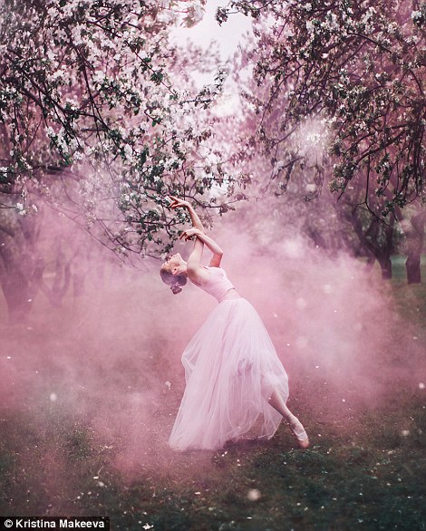 A model in a ballerina-style dress poses under a tree in a park in Moscow