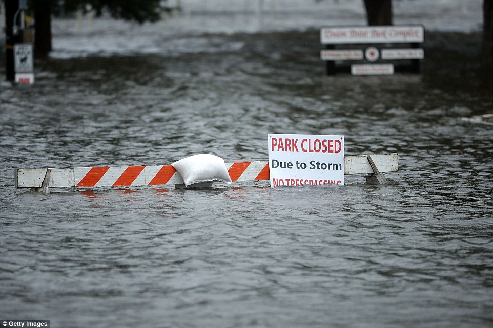A sign warns people away from Union Point Park after is was flooded by the Neuse River in New Bern, North Carolina, on Thursday