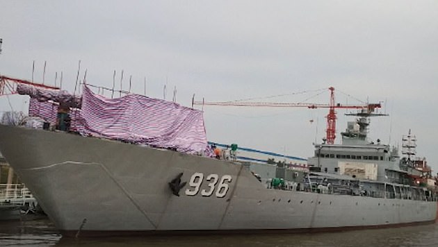 The Haiyang Shan (pictured) is part of China's East Sea Fleet. The picture shows a massive gun, believed to be the electromagnetic railgun, wrapped up at the front part of the ship