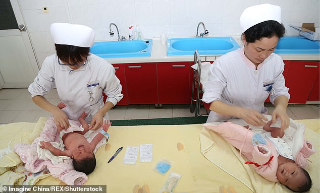 Chinese midwives take care of newborn babies at a hospital in Xiangyang city, China