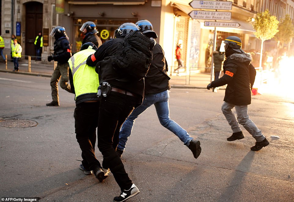 A yellow vest anti-government protestor is detained by security personnel in Rouen, north-western France on January 5, 2019, during a nationwide day of demonstrations
