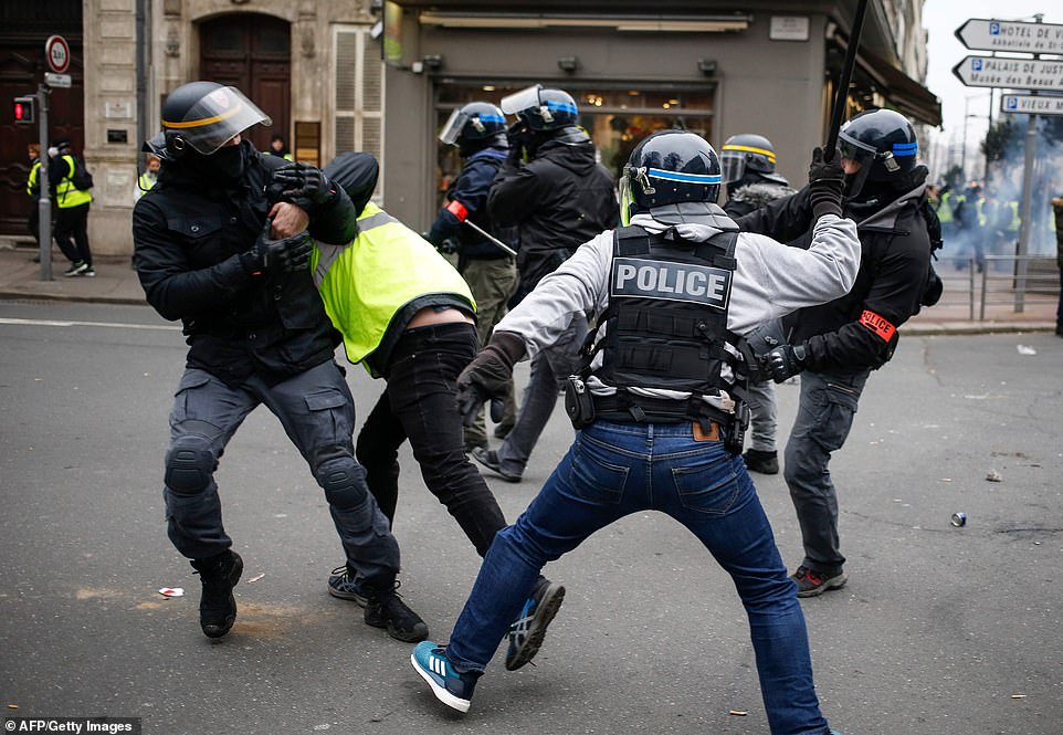 A yellow vest protestor is beaten with a baton during protests in Rouen. This is the eighth Saturday of protests called by the grass-roots movement. The numbers turning out have fallen steadily since the start of the demonstrations in November