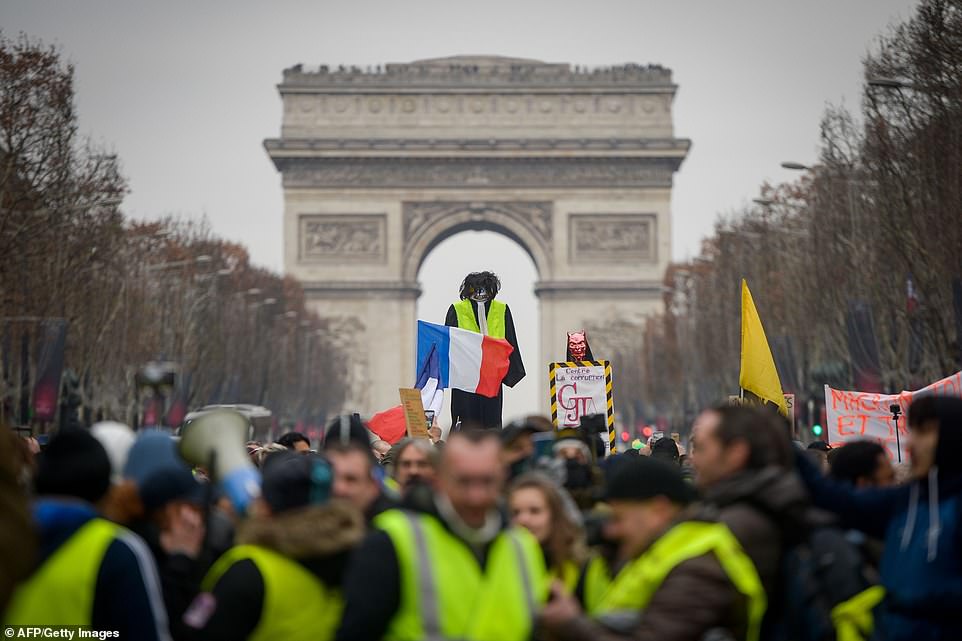 Yellow vest protestors hoist an effigy with a French national flag in front of The Arc de Triomphe on The Champs-Elysees in Paris today. In Paris, organisers called for a march from the City Hall to the National Assembly (parliament) building, and a rally on the Champs Elysees, the scene of violent clashes at previous demonstrations