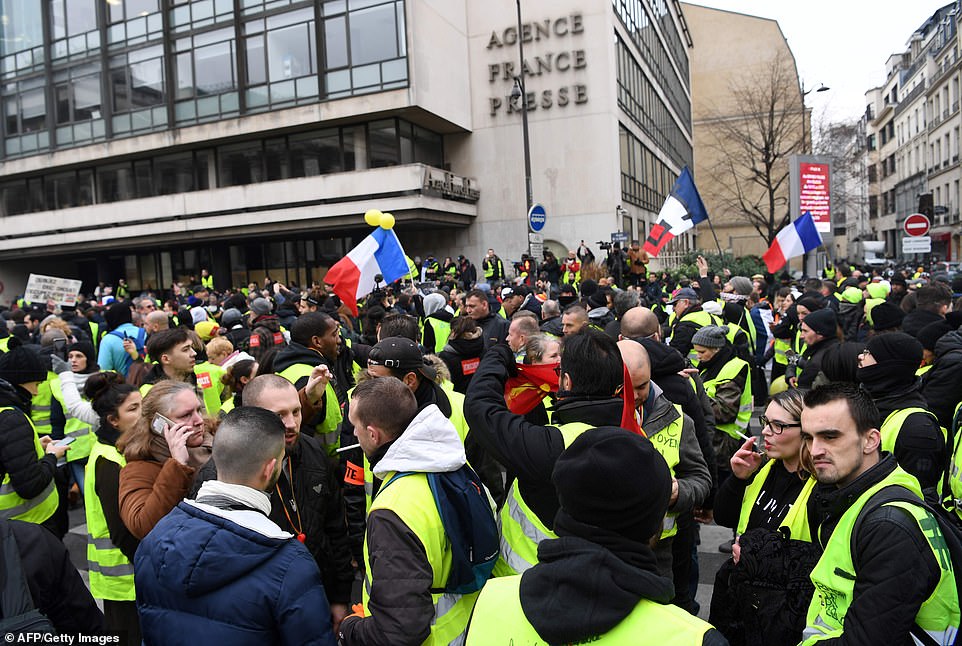 Macron initially refused to make any concessions, but in mid-December, after weeks of violence, he scrapped the planned fuel tax rises and promised extra cash for minimum wage earners and tax cuts for pensioners. The protests have caused the biggest political crisis of his 20-month presidency. Pictured are protestors outside Agence France-Presse this morning