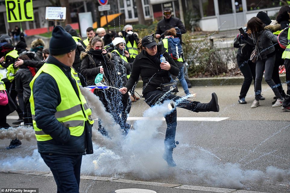 A yellow vest anti-government protester kicks a teargas shell during a rally in Nantes today. Teargas and batons were used by riot police on a so-called ‘Act VIII’ Day of Rage organised by the Yellow Vest movement