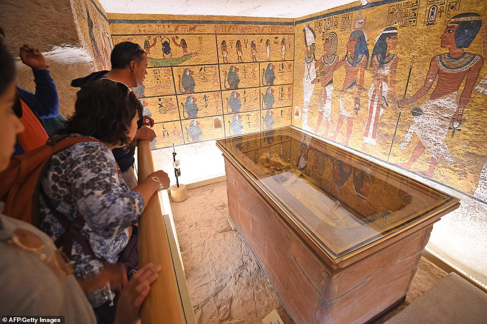 A group of tourists look at the golden sarcophagus of Tutankhamun, who has remained the most popular ancient Egyptian leader