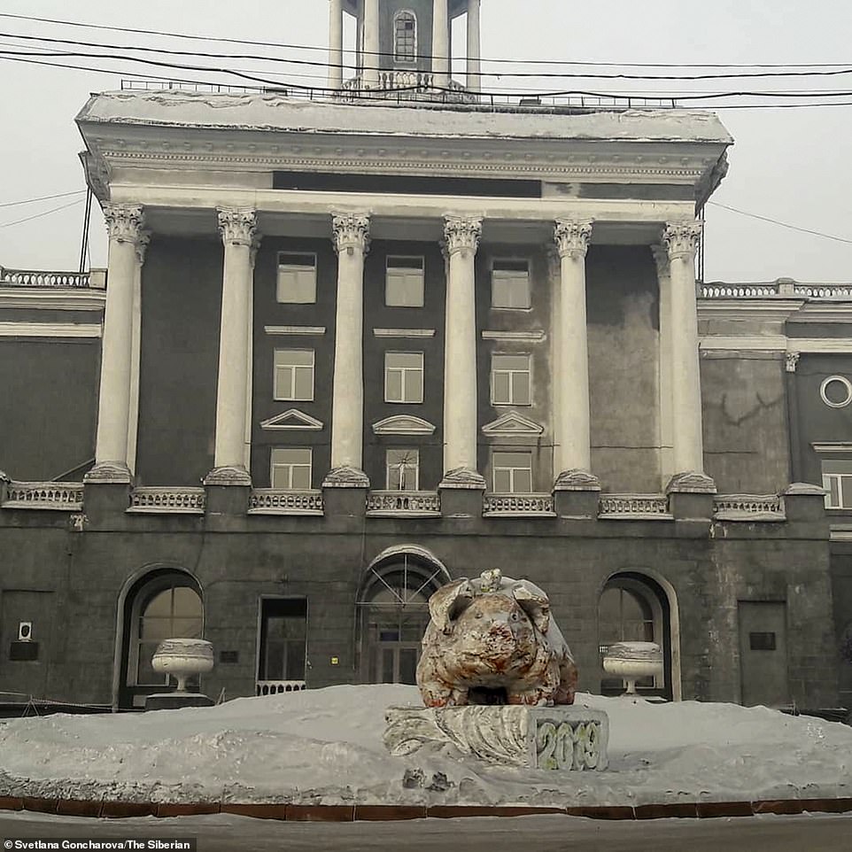 Eerie: Buildings and statues in the city of Prokopyevsk have also been covered in the creepy black dusting of snow