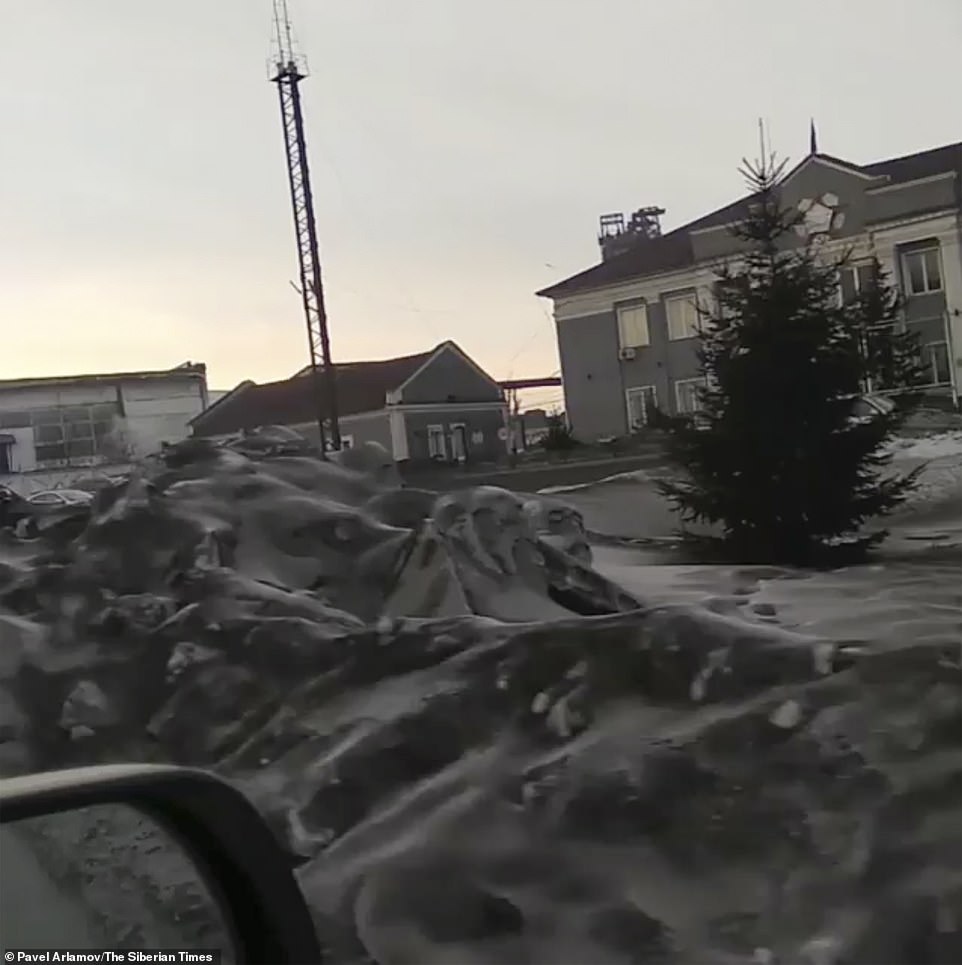 Nearby coal plants have been blamed for the blackening of the Siberian snow with some locals describing the scenes as 'hellish'Â 