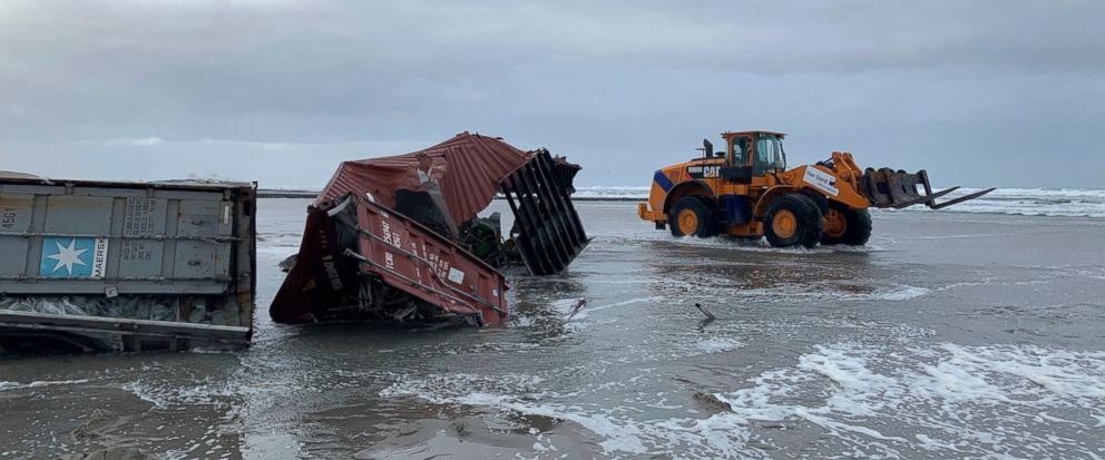 Cargo containers are removed from a beach in Vlieland, Netherlands, Friday Jan. 4, 2019, after 270 shipping containers were lost at sea by a cargo ship caught in a storm. Authorities in Germany and the Netherlands were searching for up to 270 shippin