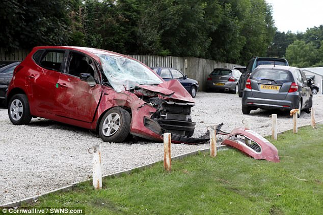 A passenger died after a car she was in crashed into 22 cars parked on a garage forecourt
