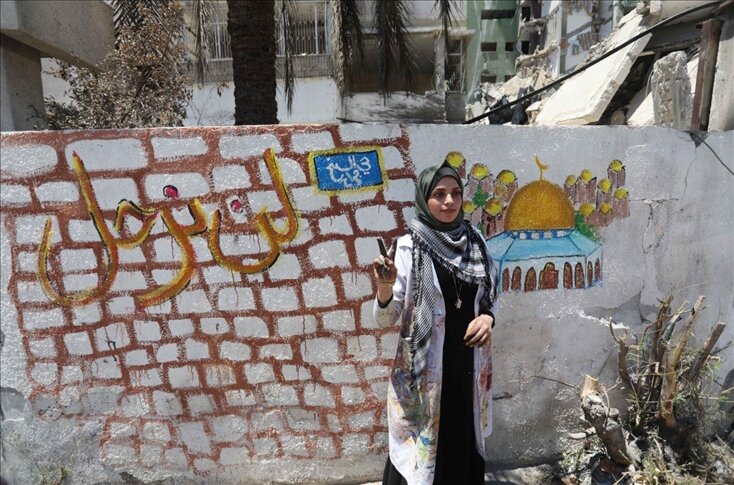 "الشيخ جرّاح" يتجسد على جدار منزل مهدوم بغزة